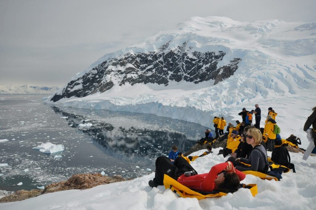 Travelers lounging at the edge of a glacier